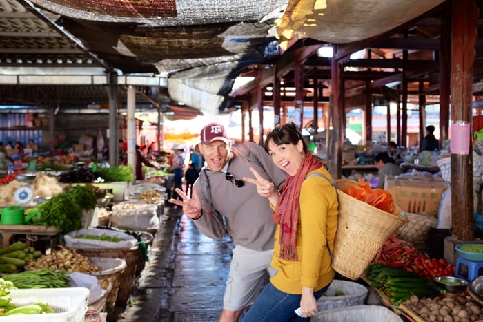 Bobby and Vanessa Robbins laughing at a local produce market