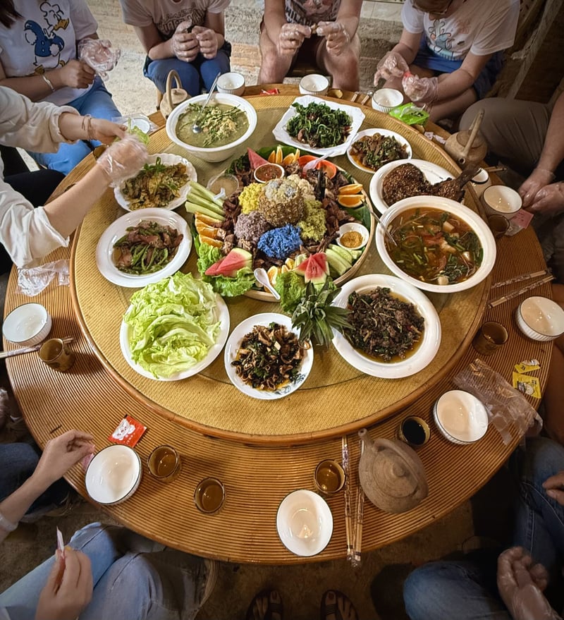 Travelers sharing a table of Yunnan dishes