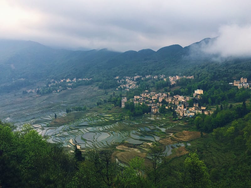 A village among the Hani rice terraces in the mist