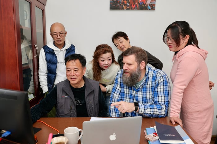 Our team planning a trip together at a laptop